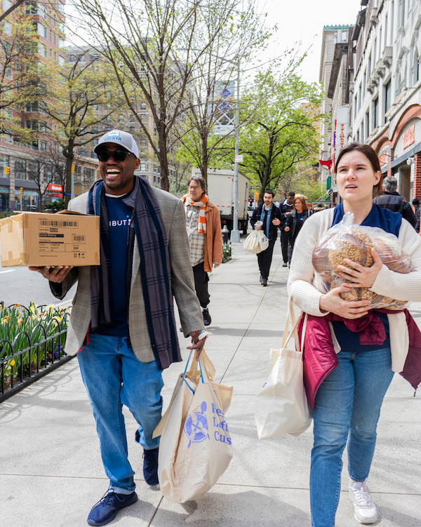 A group of volunteers carrying donated food in New York City