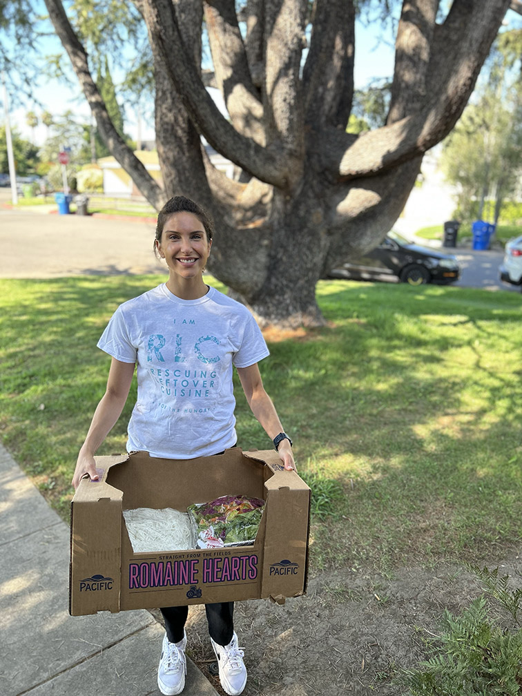 A volunteer holding donated food